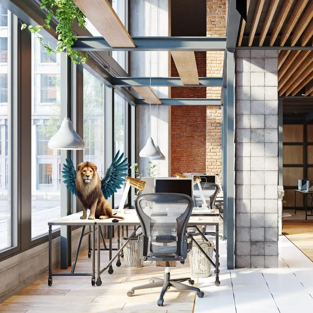 Helles Büro mit Loft-Fenstern und Schreibtisch, darauf ein geflügelter Löwe