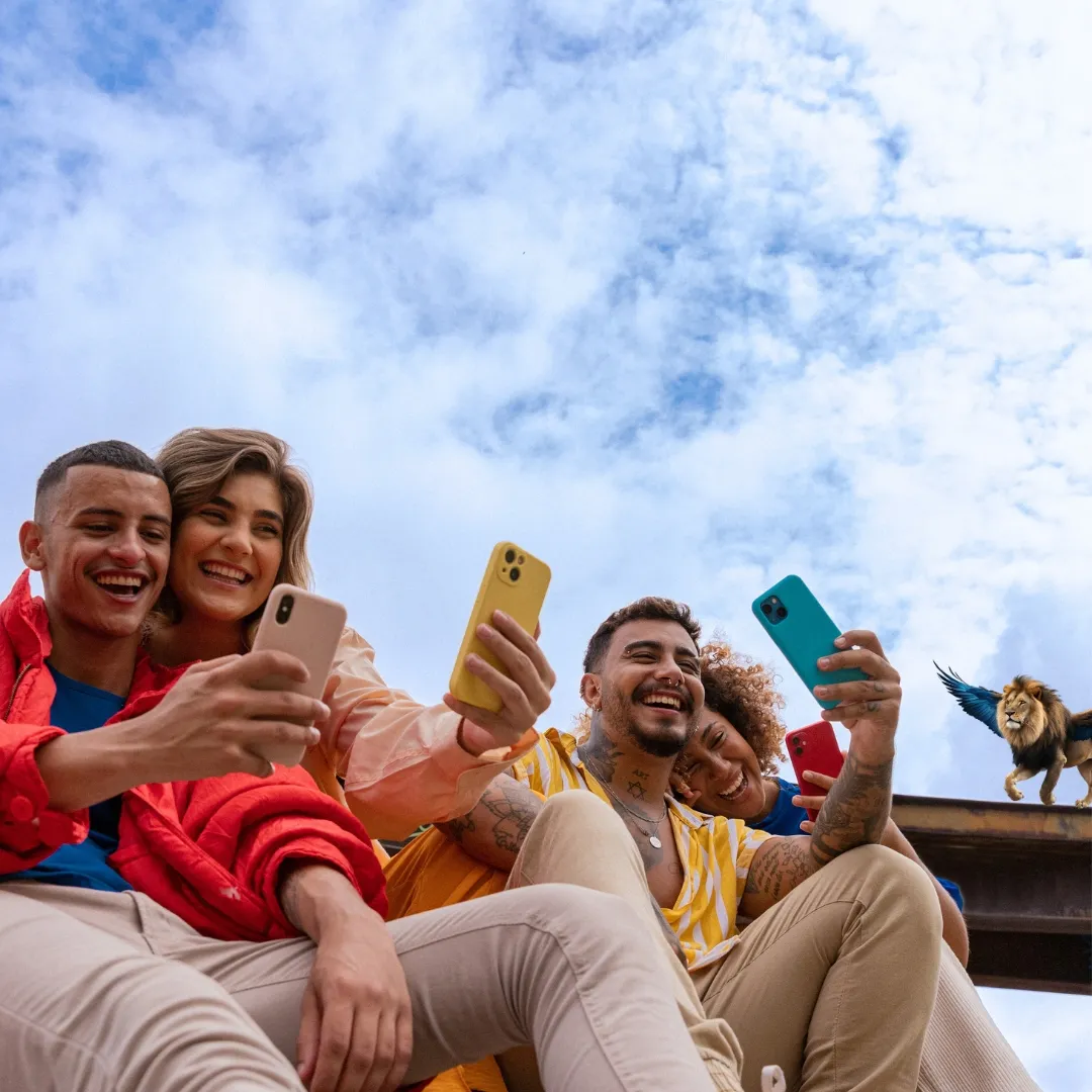Gruppe junger Menschen macht lachend ein Selfie mit dem Smartphone